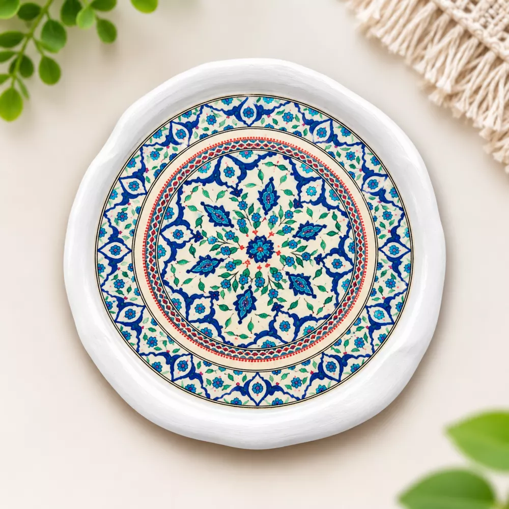 Blue floral mandala coaster on a light background.