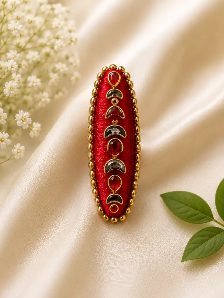 Red and black gemstone saree pin hero image.