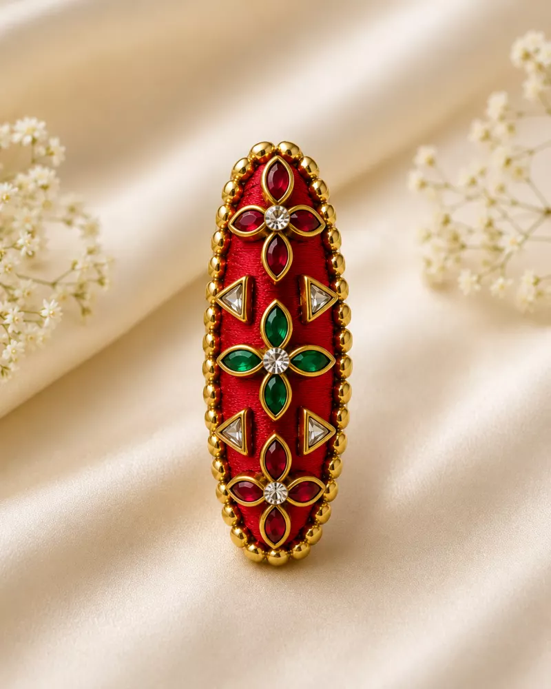 Red and green gemstone saree pin hero image.