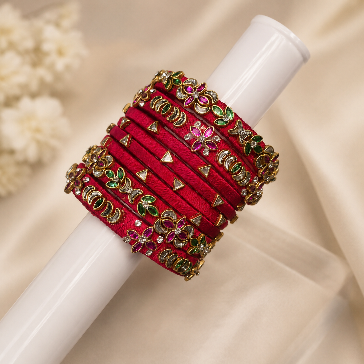 Premium close-up of red silk thread bangles.