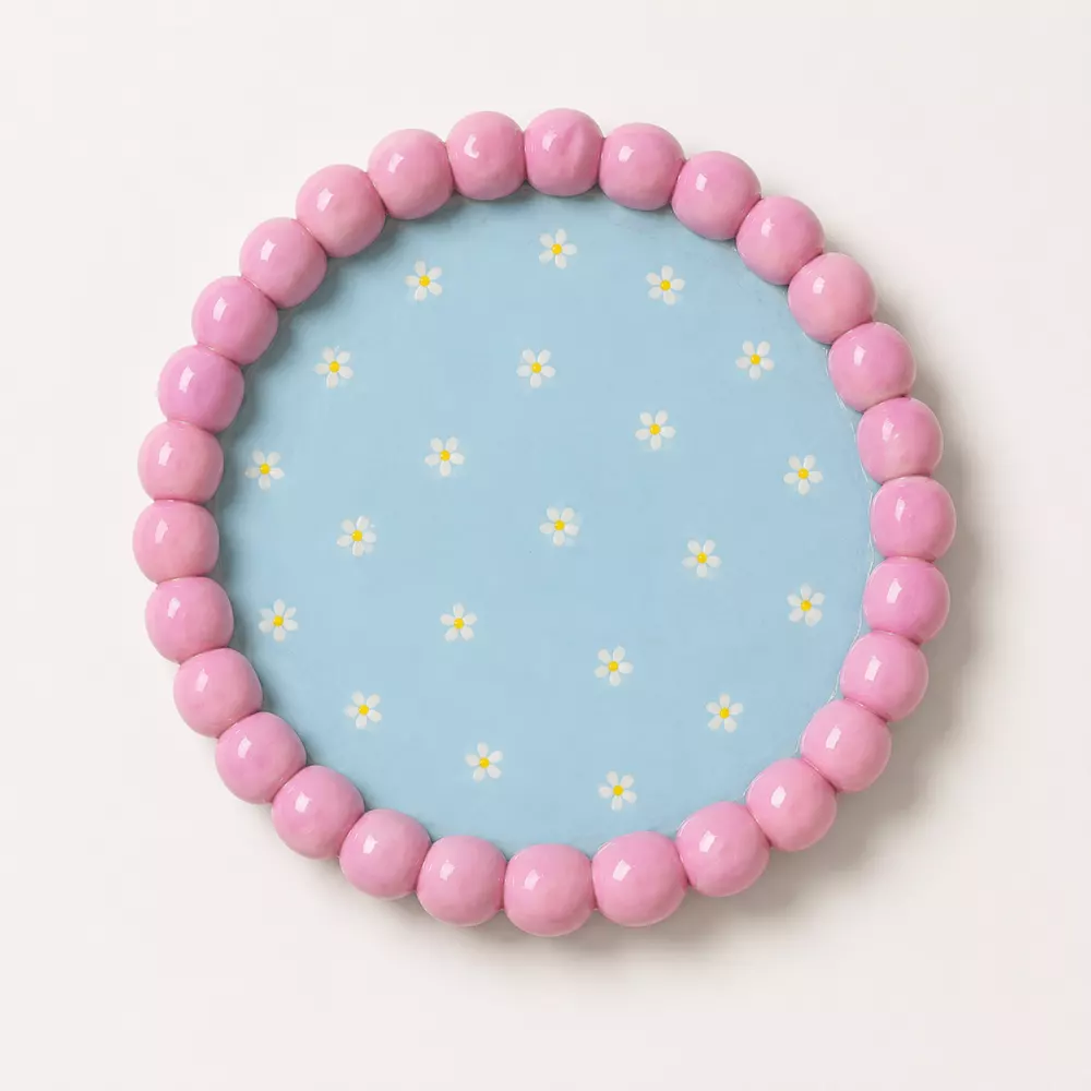 Round beaded tray in blue and pink tones.